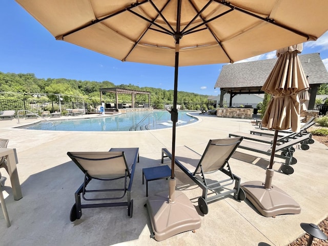 pool featuring a gazebo, a patio, fence, and a pergola