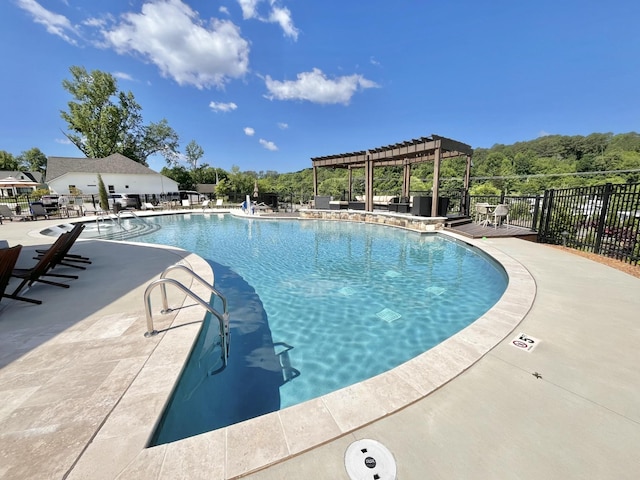 pool with fence, a patio, and a pergola