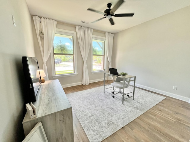 home office with ceiling fan, wood finished floors, and baseboards