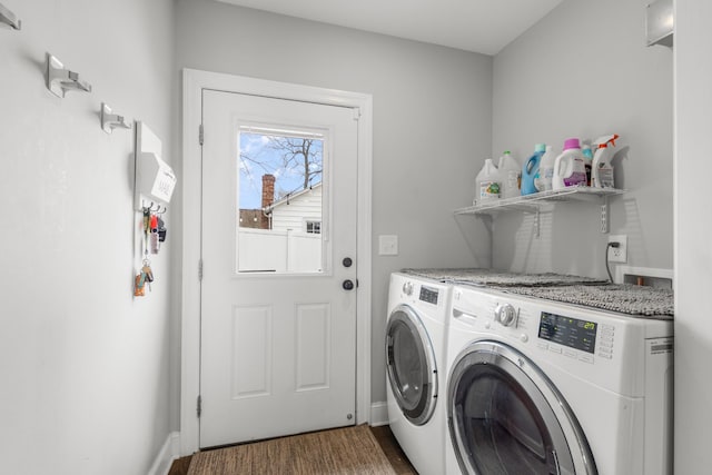 laundry room featuring laundry area, baseboards, dark wood finished floors, and washing machine and clothes dryer