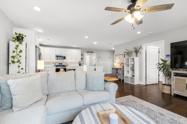 living area with a ceiling fan, dark wood-type flooring, and recessed lighting