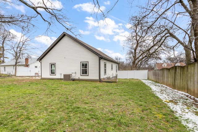 back of house featuring a fenced backyard and a yard