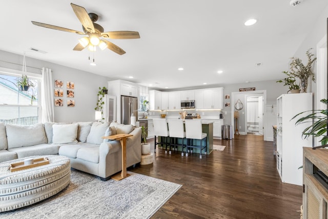 living room featuring a ceiling fan, recessed lighting, dark wood-style flooring, and visible vents