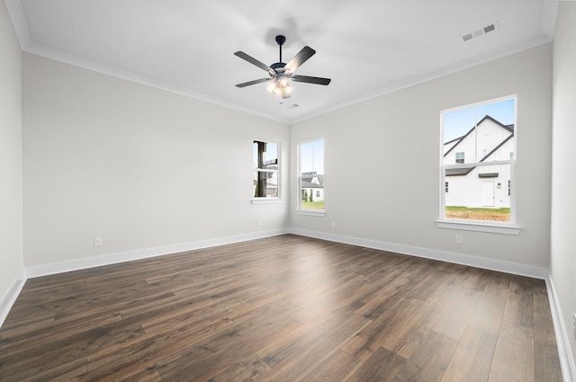 unfurnished room featuring dark wood-style flooring, crown molding, visible vents, a ceiling fan, and baseboards