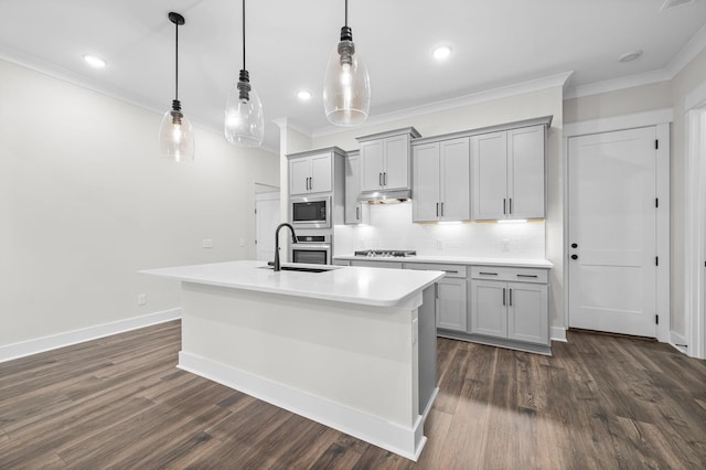 kitchen with pendant lighting, light countertops, gray cabinetry, appliances with stainless steel finishes, and under cabinet range hood