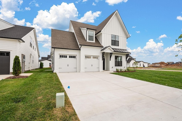 modern inspired farmhouse with driveway, a standing seam roof, a front lawn, and board and batten siding