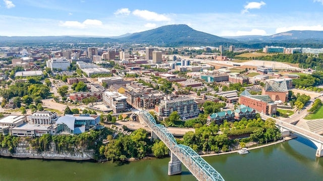 drone / aerial view with a water and mountain view and a city view