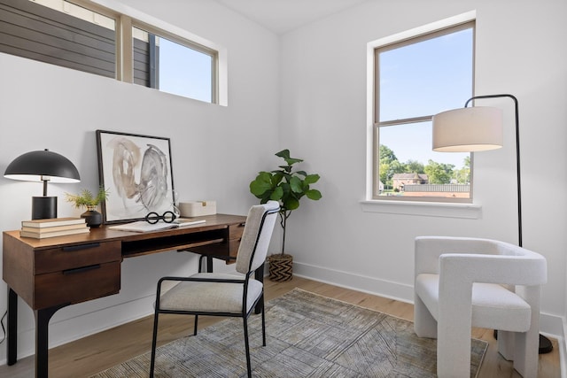 office with wood finished floors and baseboards