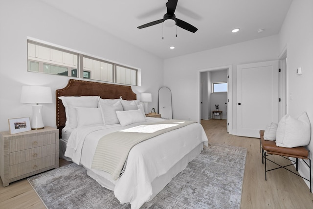 bedroom featuring light wood finished floors, a ceiling fan, and recessed lighting