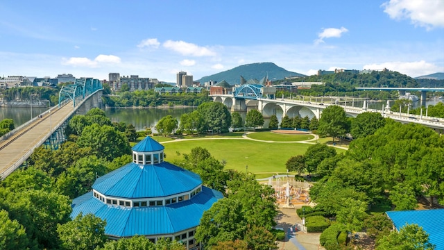 view of property's community featuring a city view, a yard, and a water and mountain view