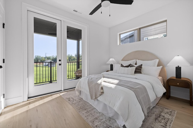 bedroom featuring ceiling fan, access to outside, visible vents, and light wood-style flooring