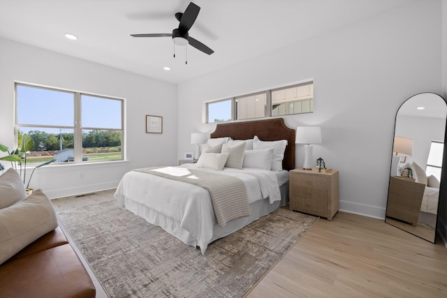 bedroom with light wood-type flooring, visible vents, baseboards, and recessed lighting