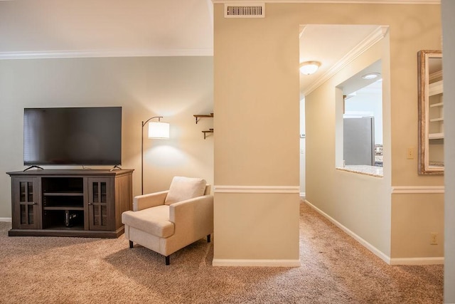 living area featuring baseboards, visible vents, carpet flooring, and ornamental molding