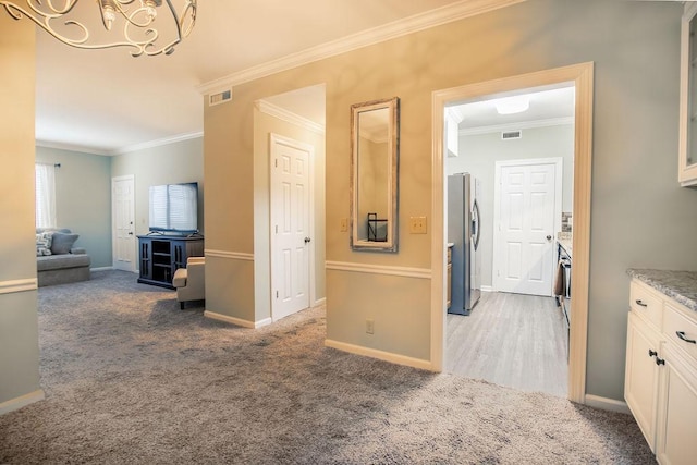 hall with ornamental molding, carpet, and baseboards