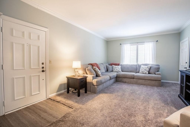 living room featuring carpet flooring, crown molding, baseboards, and wood finished floors