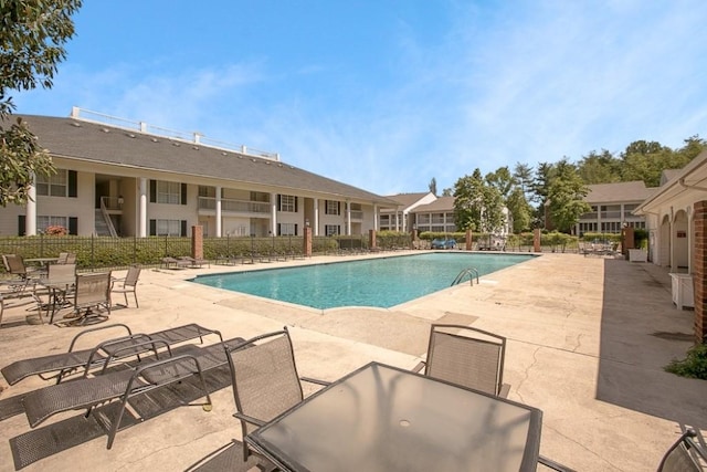 pool featuring a patio area and fence