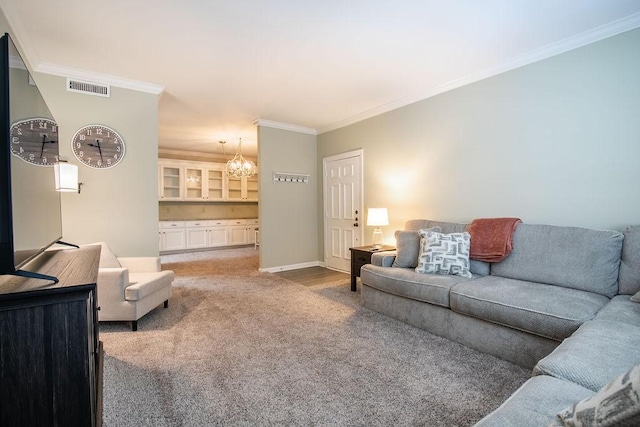 carpeted living area with baseboards, visible vents, a chandelier, and ornamental molding