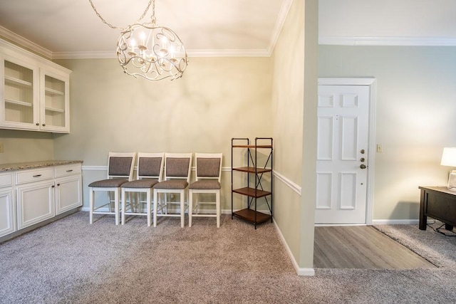 dining area with light carpet, baseboards, a notable chandelier, and crown molding