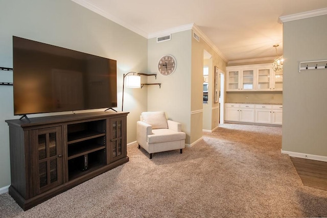 living area with visible vents, baseboards, crown molding, and light colored carpet