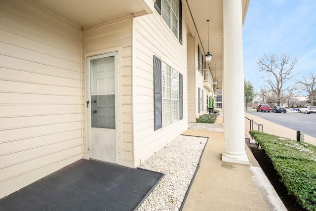 view of exterior entry with a porch