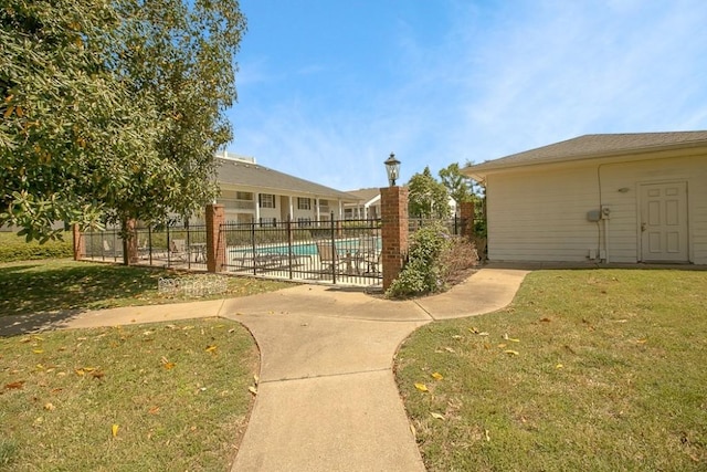 exterior space featuring fence, a fenced in pool, and a yard