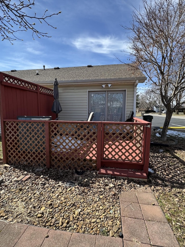 back of property with roof with shingles