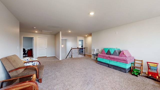 living area with carpet floors, recessed lighting, attic access, an upstairs landing, and baseboards