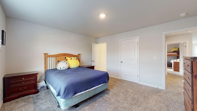 bedroom with light carpet and baseboards