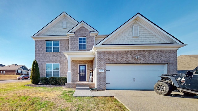 craftsman-style house with driveway, a front lawn, an attached garage, and brick siding