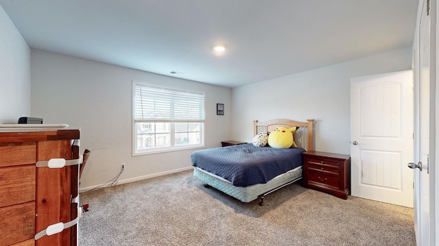 bedroom featuring light carpet, visible vents, and baseboards