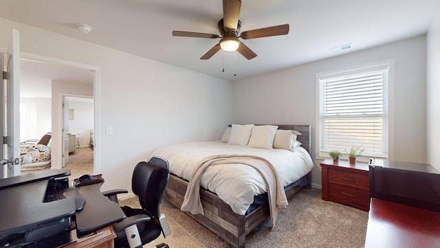 bedroom featuring a ceiling fan, light colored carpet, and visible vents