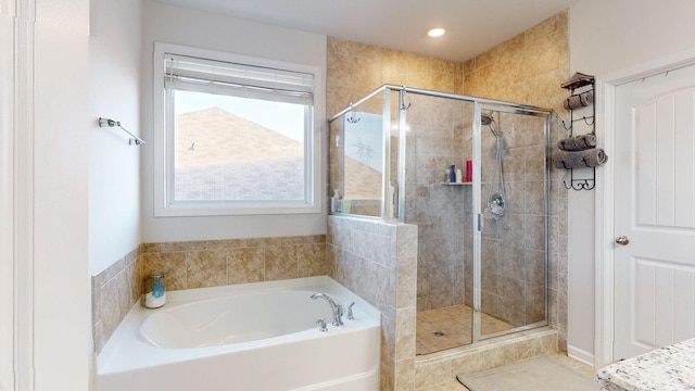 full bathroom featuring a stall shower and a bath