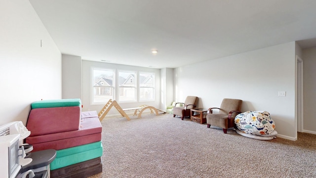 recreation room with carpet floors and baseboards