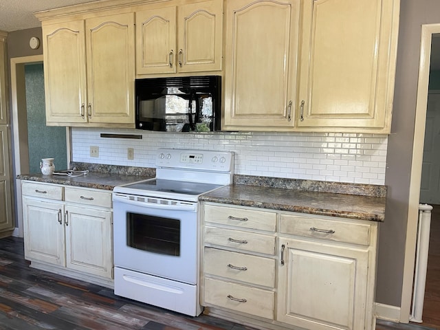 kitchen featuring black microwave, white electric range, dark wood-type flooring, and dark countertops