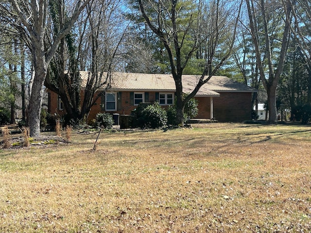 single story home with a front lawn and brick siding