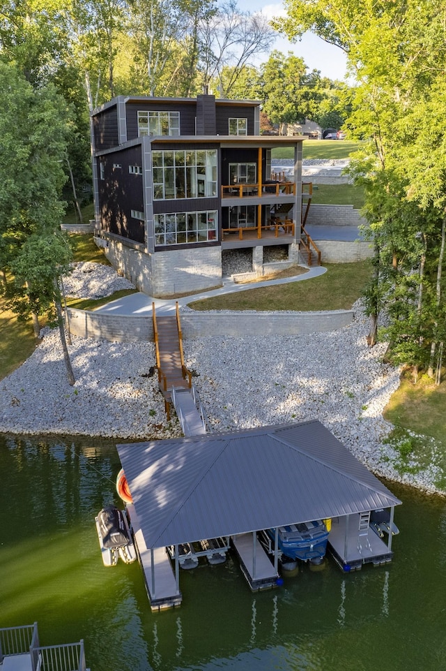 back of property featuring a water view