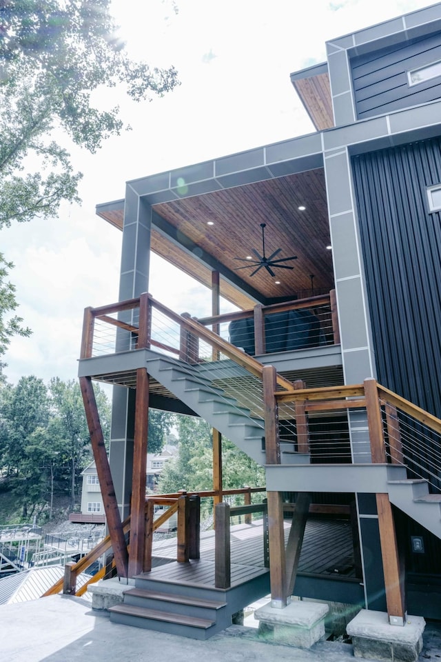 exterior space with stairs and ceiling fan