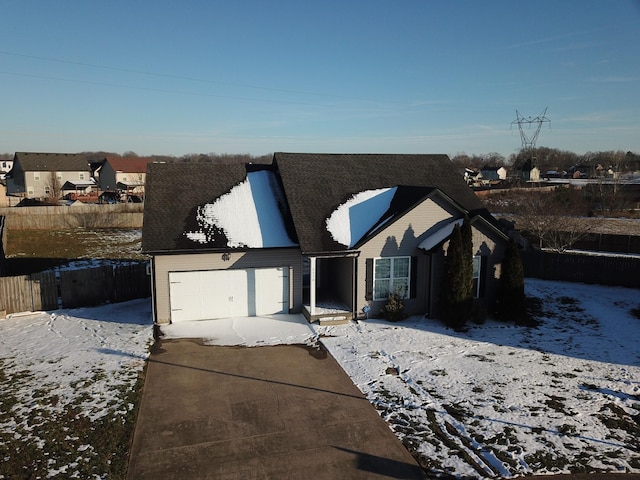 view of front of property with a garage, a residential view, and fence