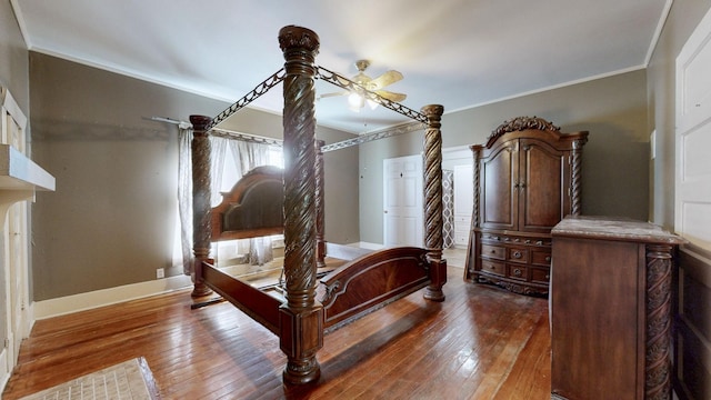 bedroom with baseboards, wood-type flooring, and crown molding