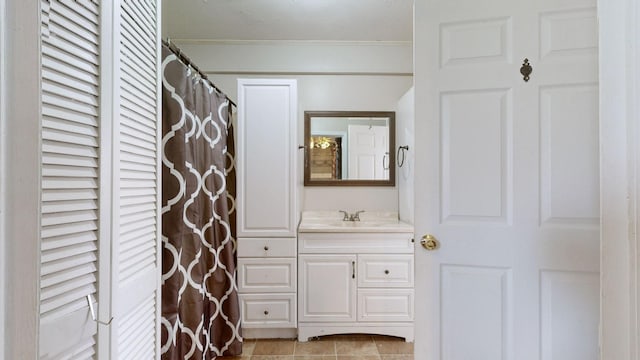 full bathroom with tile patterned flooring, crown molding, and vanity