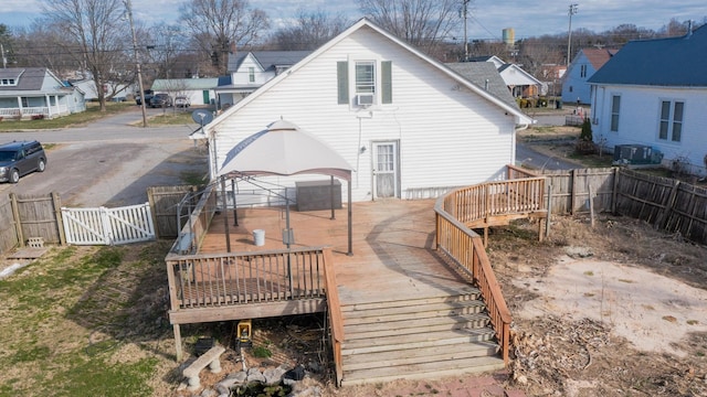 back of house with central AC, a gate, a fenced backyard, and a deck