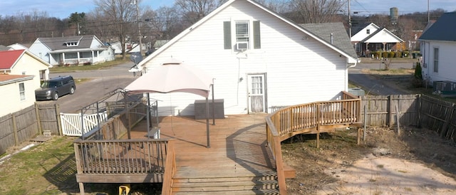 back of property featuring a fenced backyard, central AC unit, and a wooden deck