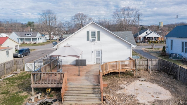 back of property featuring a fenced backyard, a residential view, and a deck