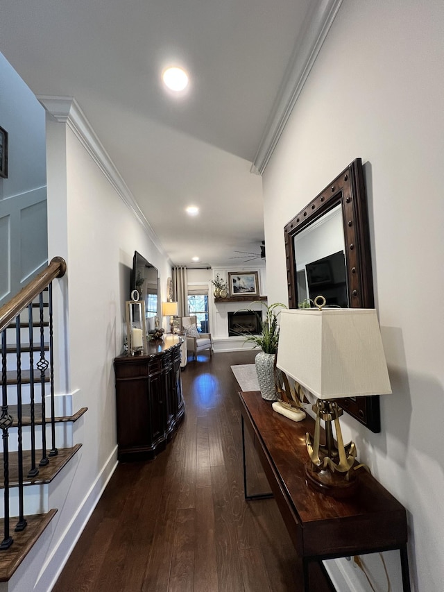 hall featuring baseboards, ornamental molding, dark wood-type flooring, stairs, and recessed lighting