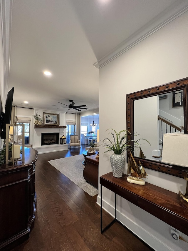 hall with baseboards, dark wood finished floors, crown molding, and recessed lighting