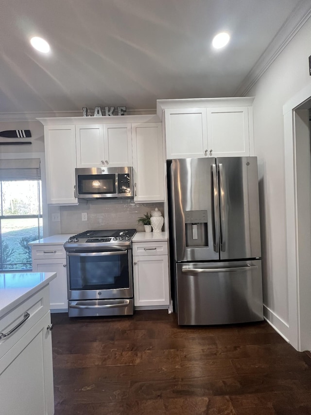 kitchen with dark wood-style floors, crown molding, stainless steel appliances, light countertops, and backsplash