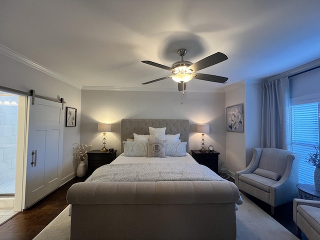 bedroom featuring a barn door, ornamental molding, and ceiling fan