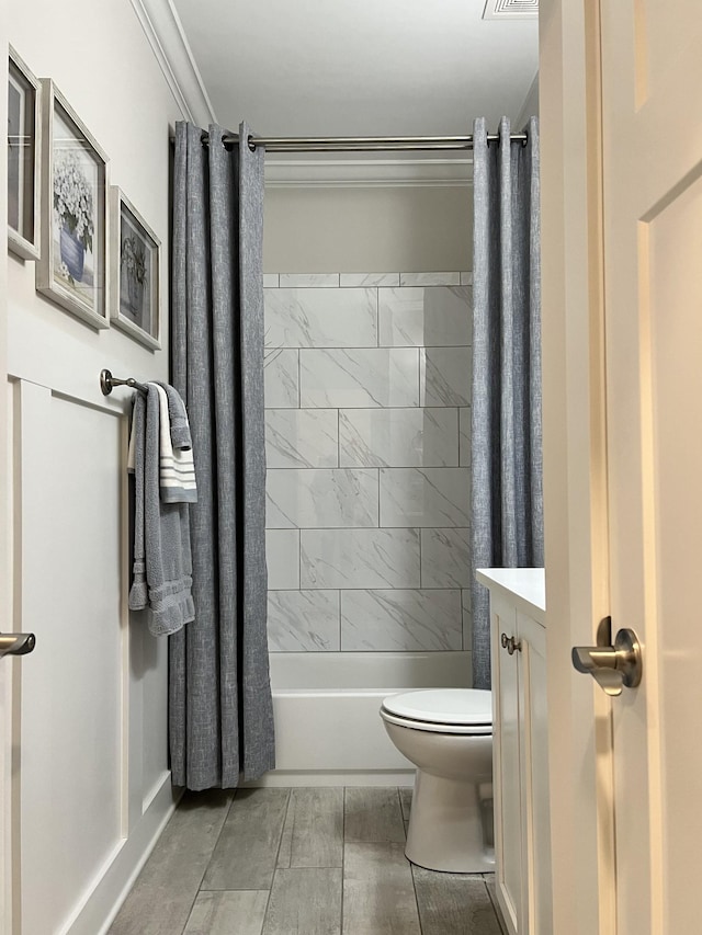 bathroom with toilet, shower / tub combo, visible vents, vanity, and crown molding