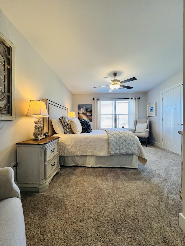 carpeted bedroom with a ceiling fan and baseboards