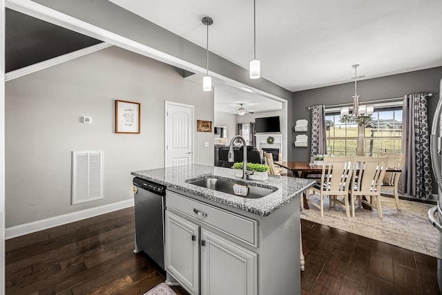 kitchen featuring a kitchen island with sink, a sink, visible vents, dishwasher, and decorative light fixtures